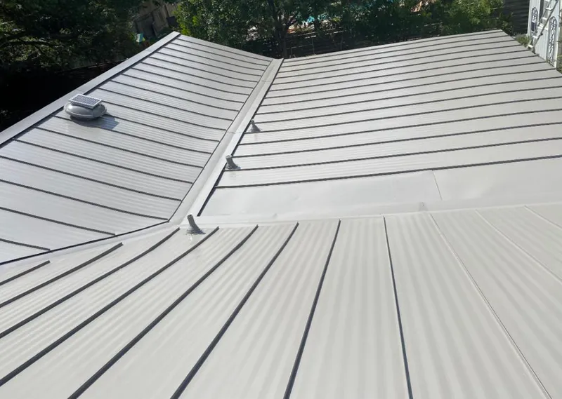 Solar attic fan installed on a metal roof for Roof Ventilation in Jacksonville